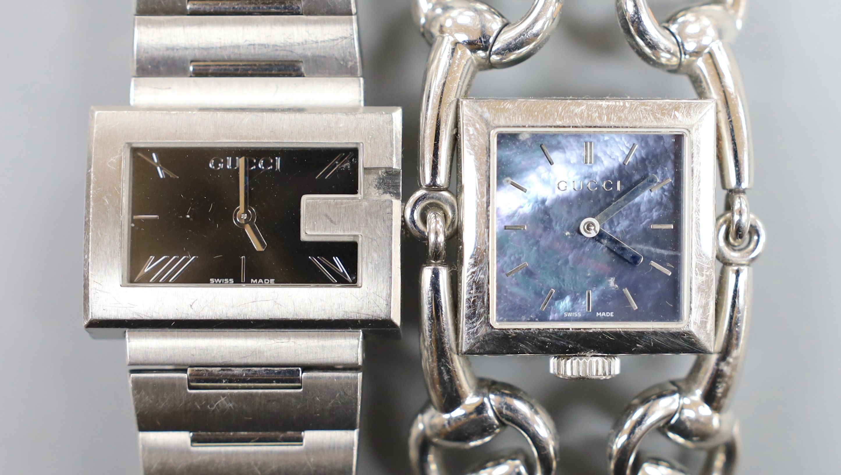 Two lady's modern steel Gucci quartz wrist watches, including one with mother of pearl dial with box.